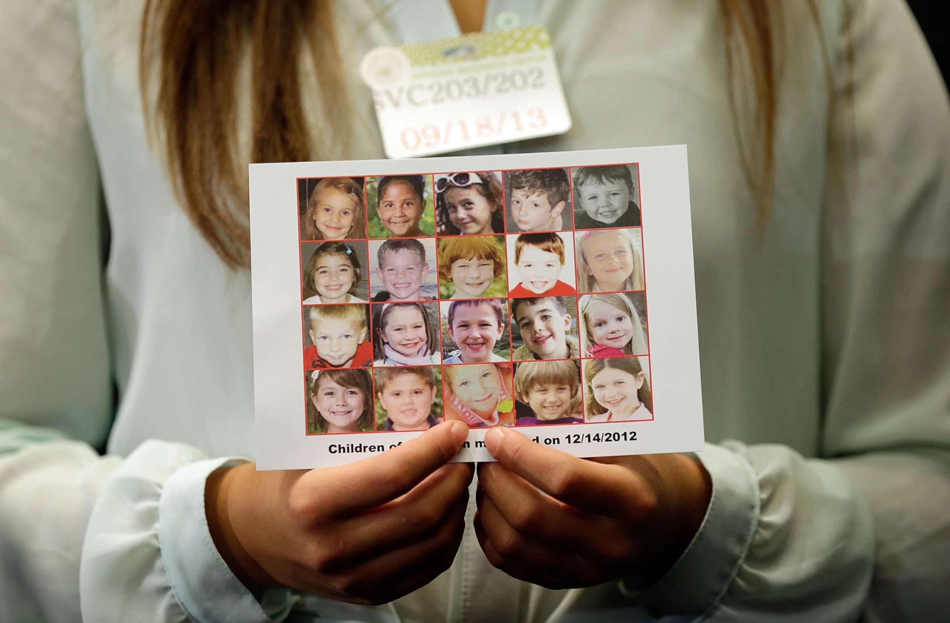 PHOTO: Kyra Murray holds a photo with victims of the shooting at Sandy Hook Elementary School during a press conference at the U.S. Capitol calling for gun reform legislation, Sept. 18, 2013, in Washington, DC.